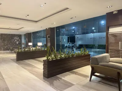a lobby with glass walls and plants on the wall at Levi & Moon's Home in Manila