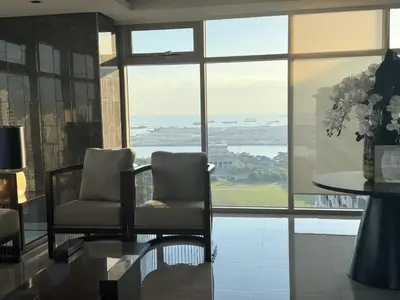 two chairs sitting in a room with a large window at Levi & Moon's Home in Manila