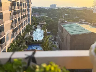 a view of a pool from a balcony of a building at Levi & Moon's Home in Manila