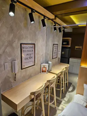 a row of tables and chairs in a room at Cozy Escape Shore 2 Tower 3 -MOA - Pasay- 2 Beds in Manila