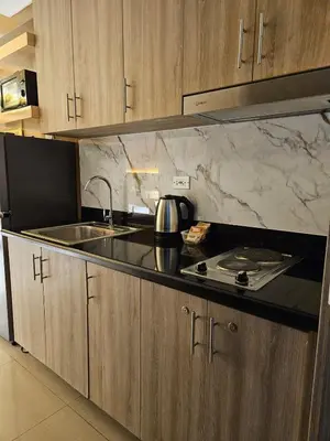 a kitchen with a sink and a counter top at Cozy Escape Shore 2 Tower 3 -MOA - Pasay- 2 Beds in Manila
