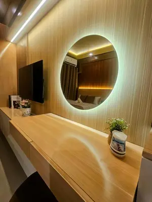 a circular mirror on a wall in a room at Cozy Escape Shore 2 Tower 3 -MOA - Pasay- 2 Beds in Manila