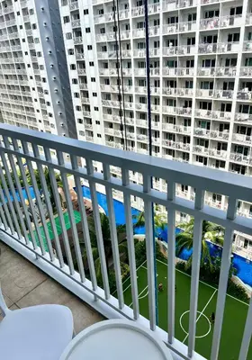 a balcony with a view of a large apartment building at Condo Room Apartment in Mall of Asia Complex Pasay City - Near Airport in Manila