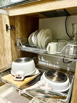 a kitchen with plates and pans on a shelf at Condo Room Apartment in Mall of Asia Complex Pasay City - Near Airport in Manila
