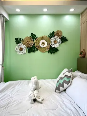 a bedroom with flowers on a green wall at Condo Room Apartment in Mall of Asia Complex Pasay City - Near Airport in Manila