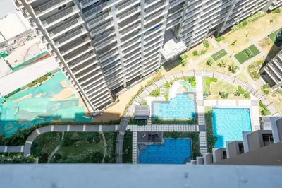 an aerial view of a building with two swimming pools at Prime 2-BR apartment near major business districts in Manila