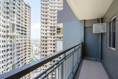 a balcony with a view of a city at Prime 2-BR apartment near major business districts in Manila