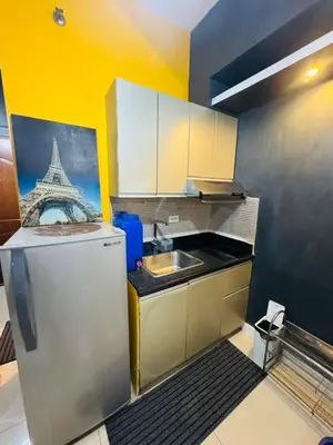 a small kitchen with a sink and a refrigerator at The Beacon Makati in Manila