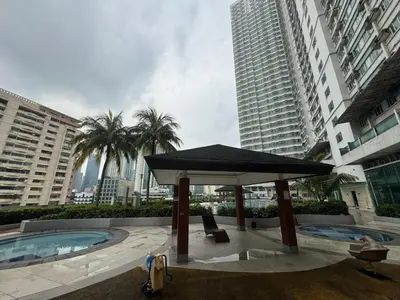 a pavilion with a large umbrella in front of buildings at The Beacon Makati in Manila