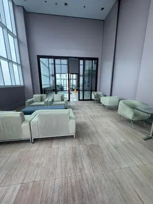a waiting room with couches and tables and windows at The Beacon Makati in Manila