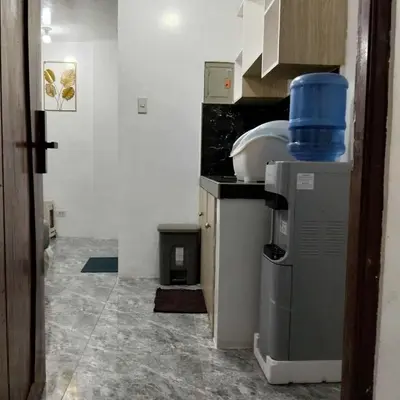 a kitchen with a counter with a blue container on it at W Tramo Residences in Manila