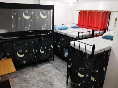 a room with two bunk beds with moon and stars at W Tramo Residences in Manila