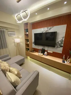 a living room with a couch and a flat screen tv at Hallin Bay Suites Modern 1BR with balcony in Manila