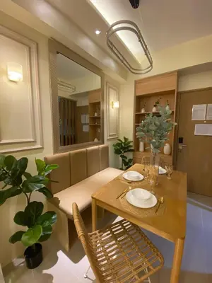 a dining room with a table and chairs at Hallin Bay Suites Modern 1BR with balcony in Manila