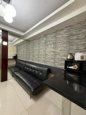 a black leather couch in a living room at Sea Residences SM Mall of Asia Cj in Manila