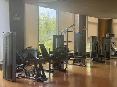 a gym with chairs and treadmills in a room at Radiance Manila bay 2 br & 3 bath in Manila