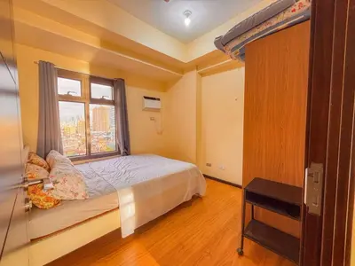 a bedroom with a bed and a window at Radiance Manila bay 2 br & 3 bath in Manila
