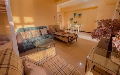 a living room with a couch and a table at Radiance Manila bay 2 br & 3 bath in Manila