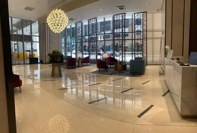 a lobby with chairs and tables in a building at 2 bedroom Luxury Condo in Eastwood with Scenic City view, unli wifi and netflix in Manila