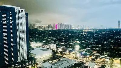 an aerial view of a city with a tall building at 2 bedroom Luxury Condo in Eastwood with Scenic City view, unli wifi and netflix in Manila