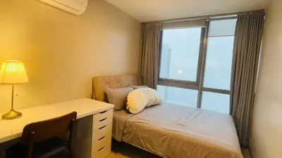 a bedroom with a bed and a desk and a window at 2 bedroom Luxury Condo in Eastwood with Scenic City view, unli wifi and netflix in Manila