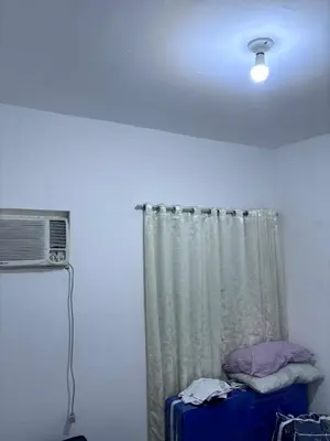 a room with a ceiling fan and a curtain at A peace and quiet home away from your home in Calamba