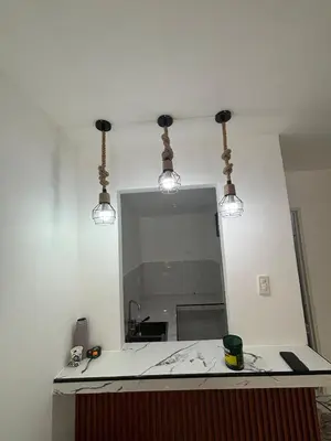 a bathroom with a mirror and lights on a counter at A peace and quiet home away from your home in Calamba