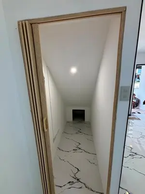 a hallway with a door into a room with marble floors at A peace and quiet home away from your home in Calamba