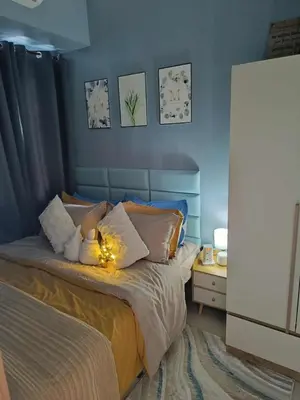 a bedroom with a bed with a teddy bear on it at SkyShore Suites in Manila