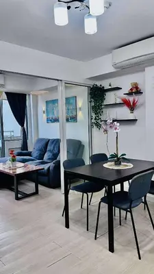 a living room with a table and a couch at L A Azure staycation in Manila