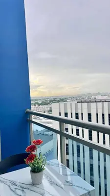 a vase of flowers sitting on a table on a balcony at L A Azure staycation in Manila