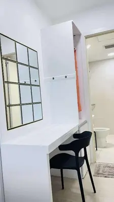 a white desk with a black chair and a mirror at L A Azure staycation in Manila