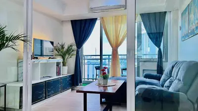 a living room with a blue chair and a table at L A Azure staycation in Manila