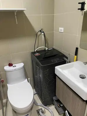 a bathroom with a toilet and a sink at Staycation Delight by R2CK in Manila