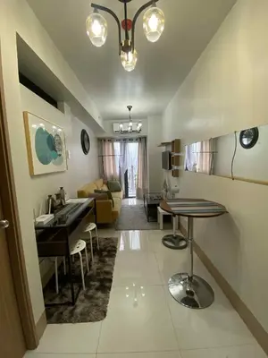 a living room with a table and a dining room at Staycation Delight by R2CK in Manila