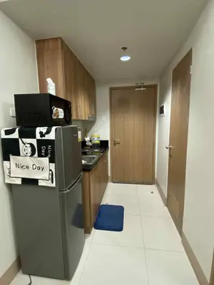 a kitchen with a refrigerator with a nice day sign on it at Staycation Delight by R2CK in Manila