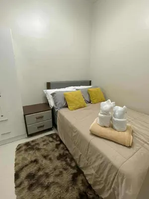 a bedroom with a bed with towels on it at Staycation Delight by R2CK in Manila