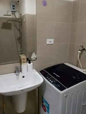 a small bathroom with a sink and a toilet at Jaina Staycation in Manila