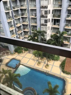 a view from the balcony of a building with a swimming pool at Sun Property in Manila