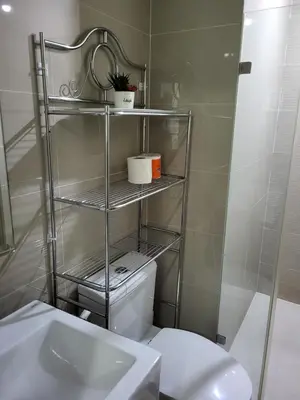 a bathroom with a white toilet and a sink at Liana's Condo Newport City in Manila