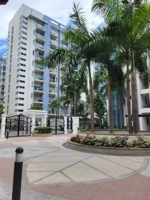 a courtyard with palm trees in front of a building at Liana's Condo Newport City in Manila
