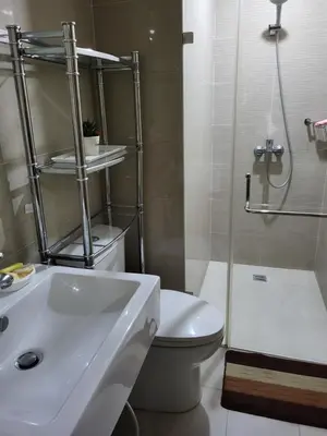 a bathroom with a sink and a toilet and a shower at Liana's Condo Newport City in Manila