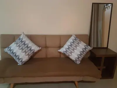 two pillows sitting on a couch in a living room at Liana's Condo Newport City in Manila