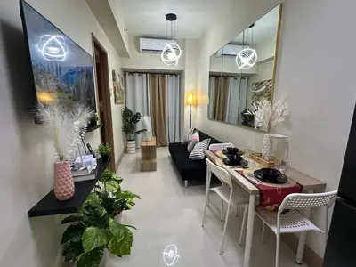 a living room with a couch and a table and chairs at jastmypads and staycation in Manila