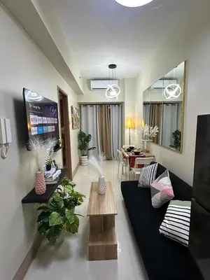 a living room with a couch and a table at jastmypads and staycation in Manila