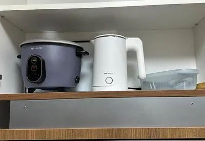 a kitchen counter with a slow cooker and a toaster at jastmypads and staycation in Manila
