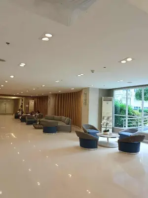 a lobby with couches and tables in a building at Tower F Sea Residence in Manila