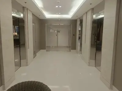 a hallway with a white floor in a building at Sea Residences Golden Empire in Manila