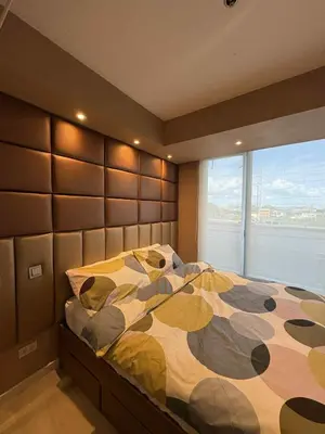 a bedroom with a large bed with a large window at La Casa 543 in Manila