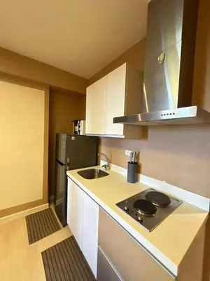 a small kitchen with a sink and a stove at La Casa 543 in Manila